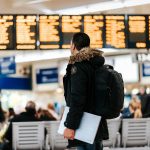 Man watching a timetable of planes